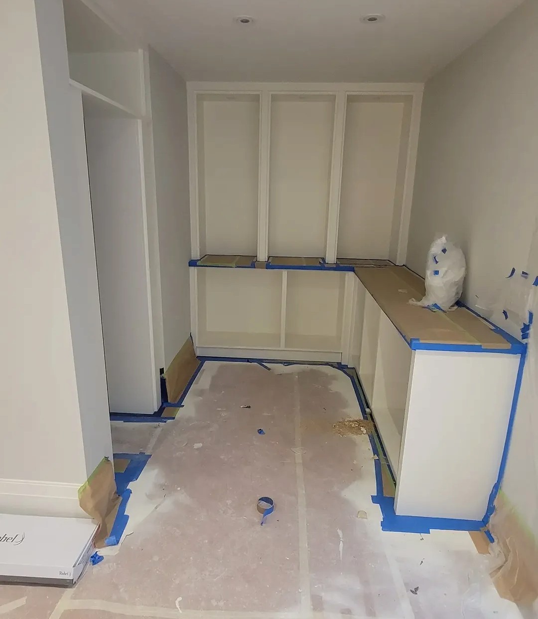 Primed MDF built-ins masked with blue tape