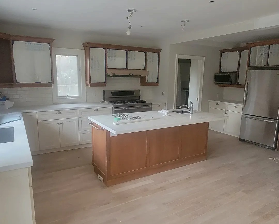 Oak kitchen cabinets masked and prepared for painting