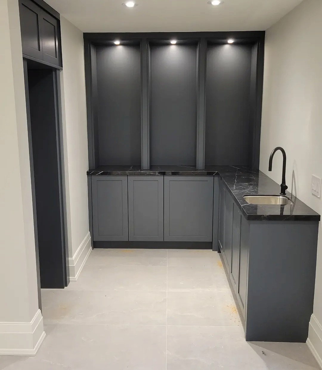 Charcoal satin painted built-ins with lighting and black hardware